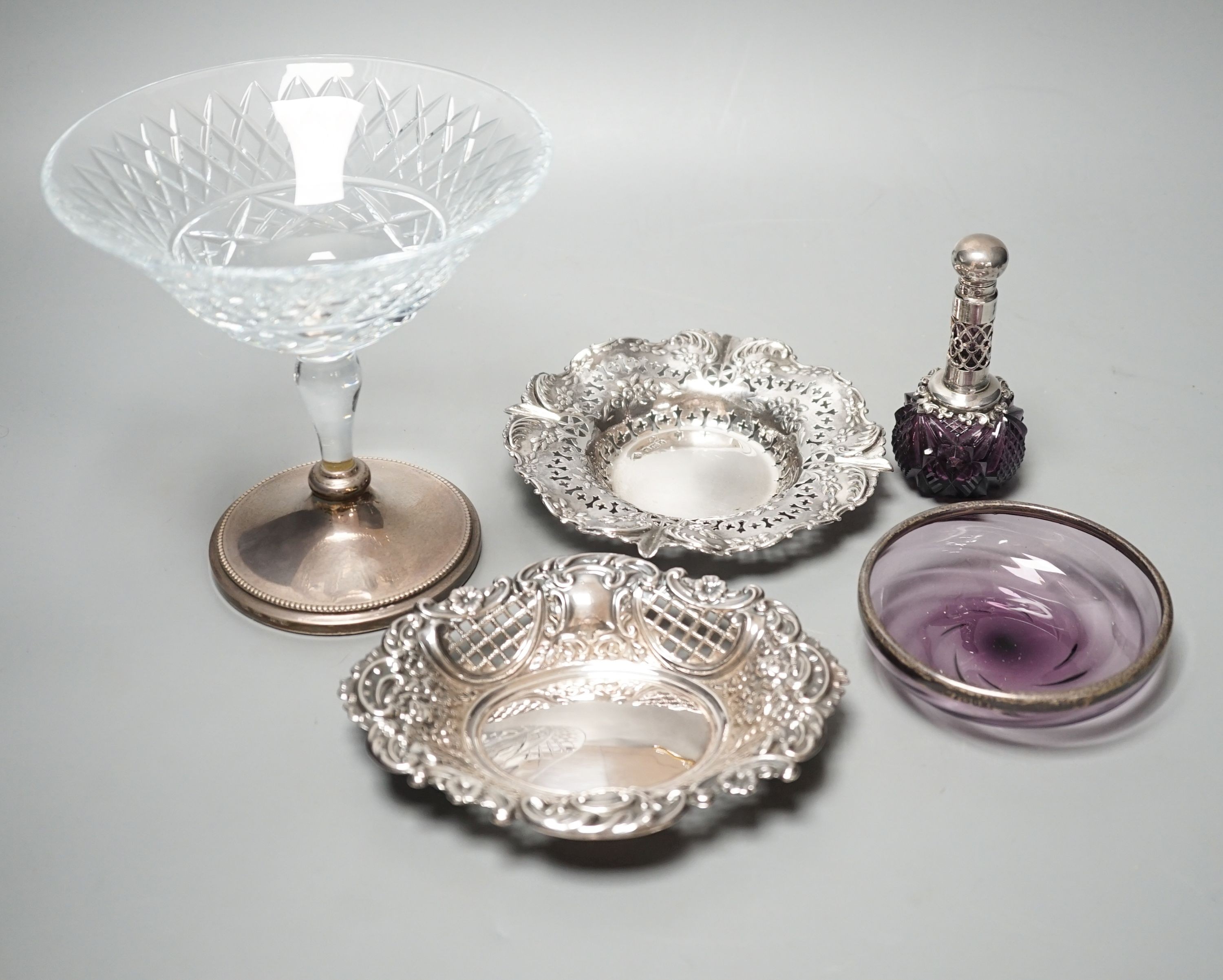 Two pierced silver trinket dishes, a late Victorian silver mounted amethyst glass dish, a similar scent flask and a silver mounted glass bowl.